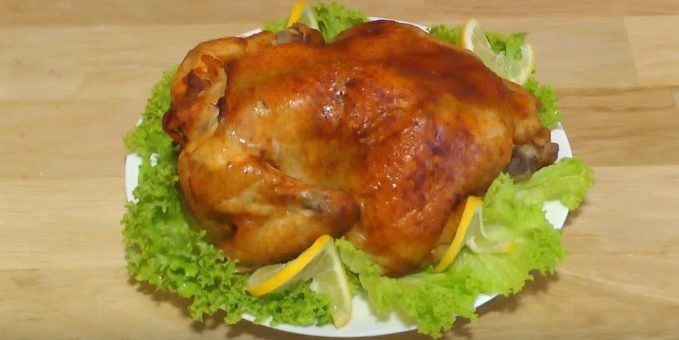 Un pollo entero en el horno con salsa picante de soja, cocido al horno en el manguito