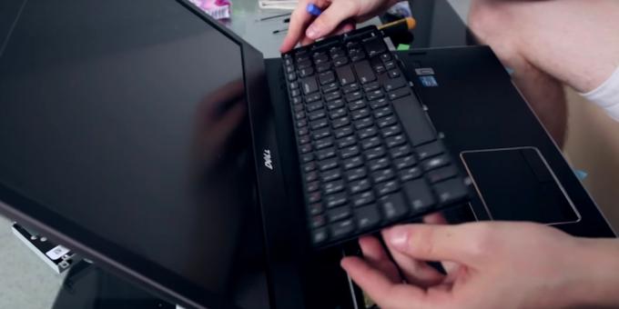 pestillos de palanca mediador en el perímetro del teclado y levante con cuidado a la computadora portátil limpia