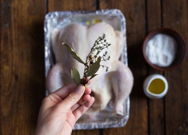 Pollo al horno de limón: ponga tomillo y lavrushka en el pollo